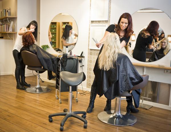 two stylist working on clients in a salon